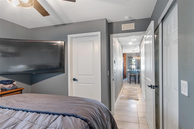 bedroom with light tile flooring and ceiling fan