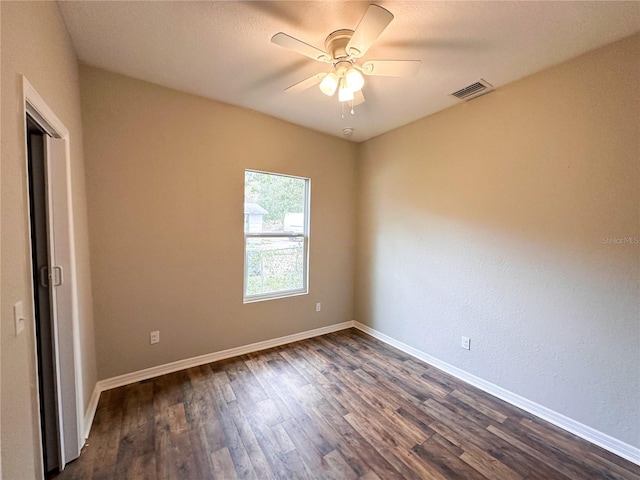 unfurnished room featuring ceiling fan and dark hardwood / wood-style flooring