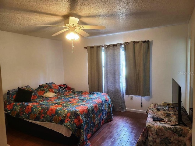 bedroom featuring ceiling fan, a textured ceiling, baseboards, and dark wood-style flooring