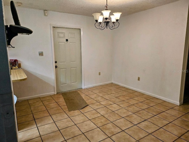 4450 Old Berkley Rd, Auburndale, FL 33823 - unfurnished dining area featuring a textured ceiling, a chandelier, and light tile patterned floors