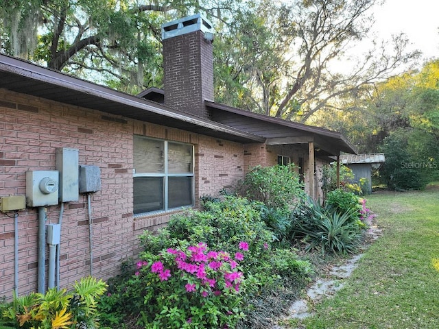 4450 Old Berkley Rd, Auburndale, FL 33823 - view of side of home with a chimney and brick siding