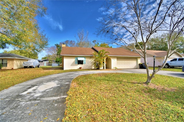 ranch-style home with a front yard and a garage