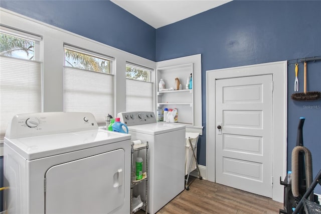 laundry room with wood-type flooring and washing machine and clothes dryer