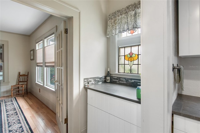 interior space featuring plenty of natural light, crown molding, and hardwood / wood-style flooring