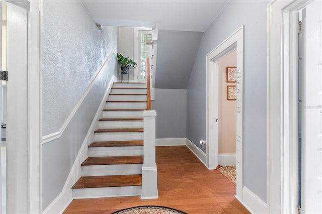 staircase featuring light wood-type flooring