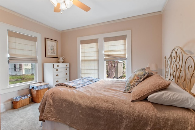 bedroom with light colored carpet, ceiling fan, and crown molding