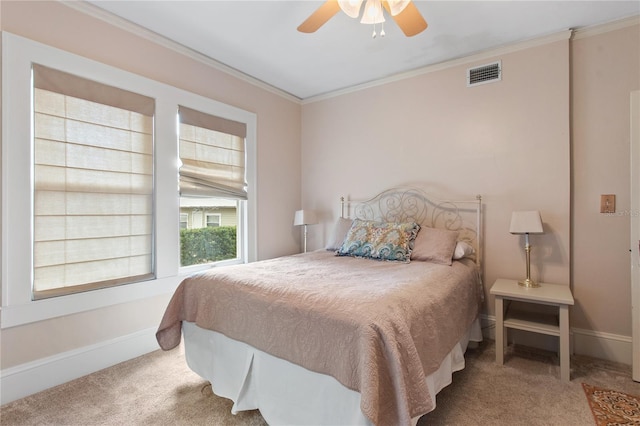 bedroom with crown molding, light colored carpet, and ceiling fan