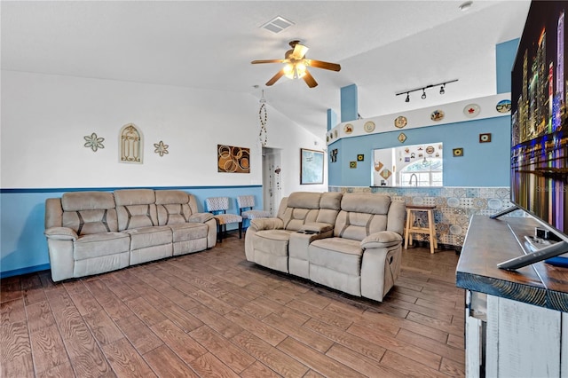 living room featuring rail lighting, high vaulted ceiling, ceiling fan, and hardwood / wood-style flooring