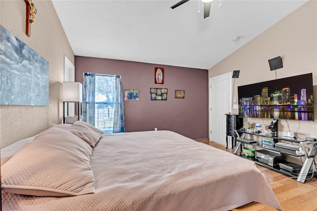 bedroom with vaulted ceiling, ceiling fan, and light wood-type flooring