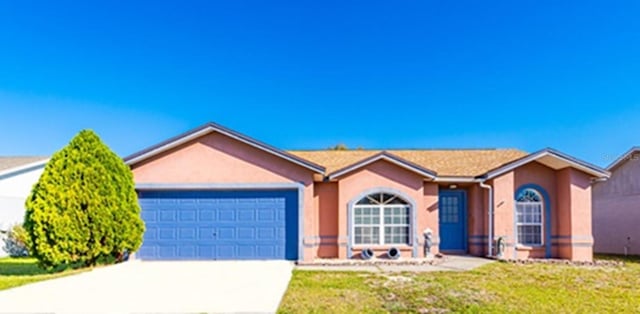 ranch-style home featuring a garage