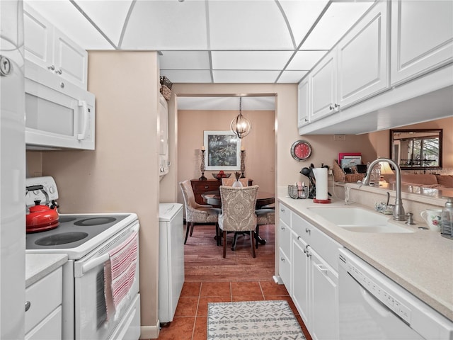 kitchen with white cabinetry, light tile flooring, white appliances, sink, and pendant lighting