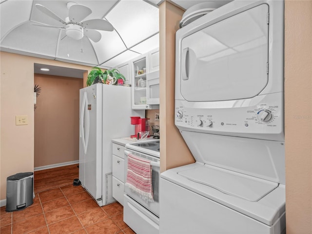 clothes washing area featuring light tile flooring, ceiling fan, and stacked washer / drying machine