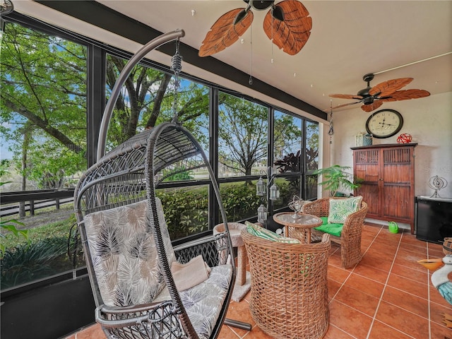 sunroom / solarium featuring ceiling fan