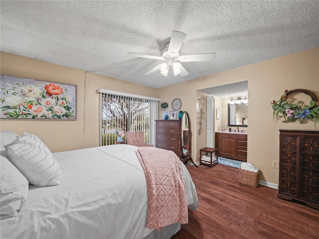 bedroom featuring connected bathroom, ceiling fan, sink, dark wood-type flooring, and a textured ceiling