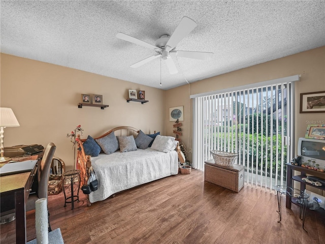 bedroom with access to outside, a textured ceiling, ceiling fan, and dark hardwood / wood-style flooring