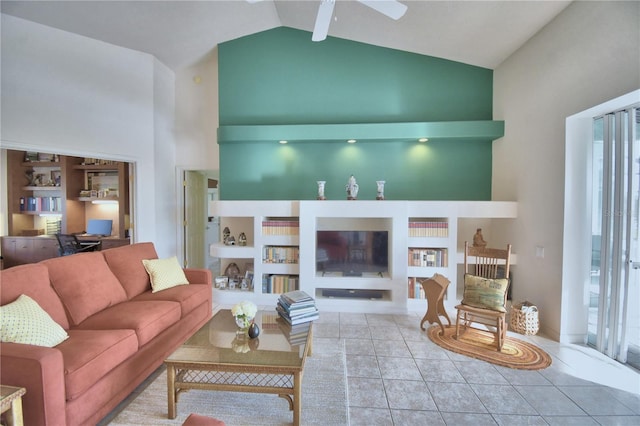 tiled living room with high vaulted ceiling, ceiling fan, and built in shelves