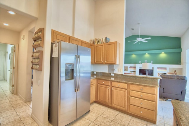 kitchen with light tile floors, stainless steel fridge with ice dispenser, ceiling fan, and high vaulted ceiling