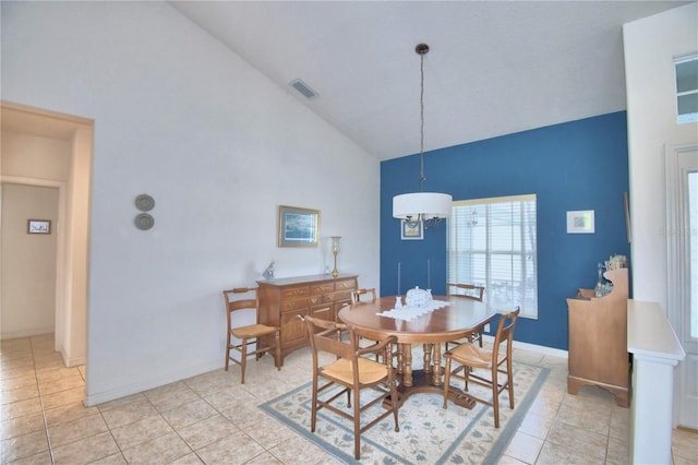 dining room with an inviting chandelier, high vaulted ceiling, and light tile flooring