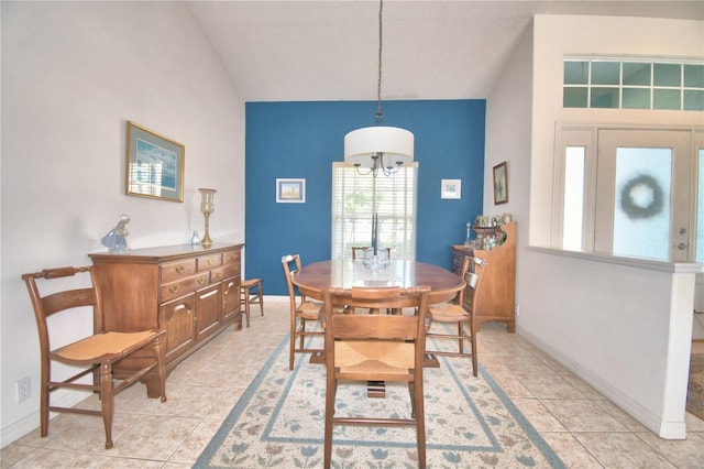 dining area featuring a chandelier and light tile floors