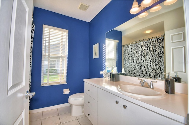 bathroom with vanity, tile flooring, a wealth of natural light, and toilet