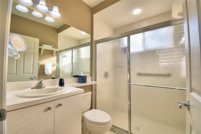 bathroom featuring toilet, an enclosed shower, and vanity