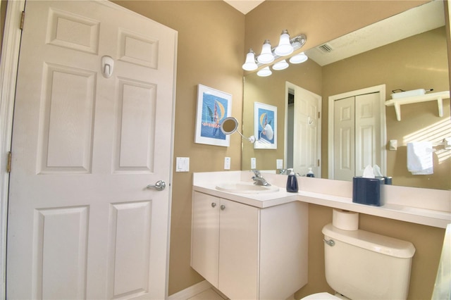 bathroom featuring toilet and vanity with extensive cabinet space