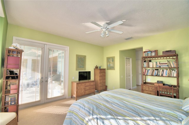 bedroom featuring french doors, access to exterior, ceiling fan, light carpet, and a textured ceiling