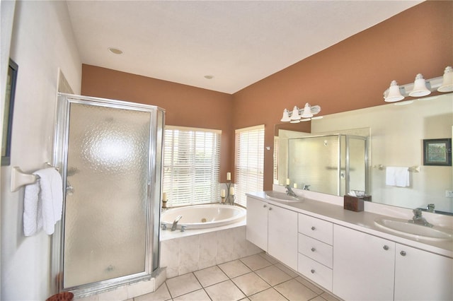 bathroom featuring tile floors, vanity with extensive cabinet space, plus walk in shower, and double sink