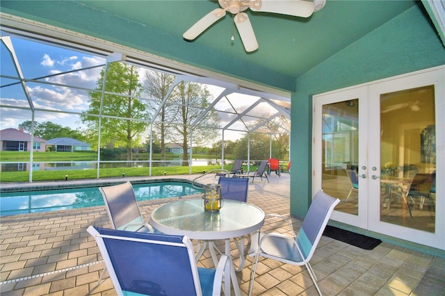 sunroom / solarium featuring lofted ceiling, ceiling fan, and french doors