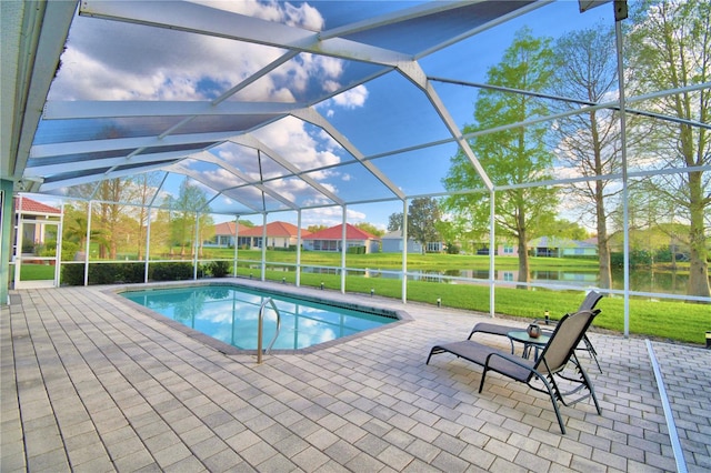 view of swimming pool with a lawn, a patio, and a lanai