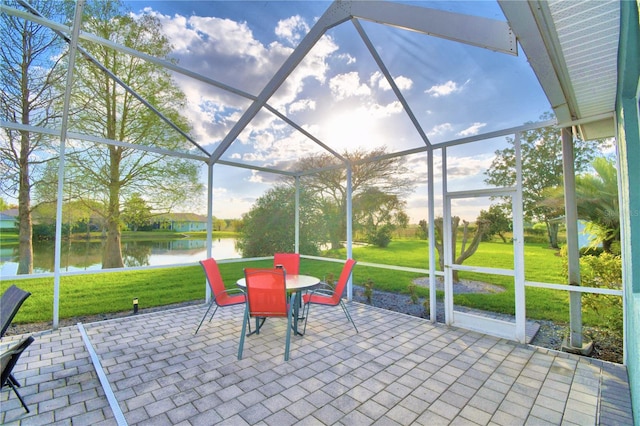 unfurnished sunroom featuring a water view