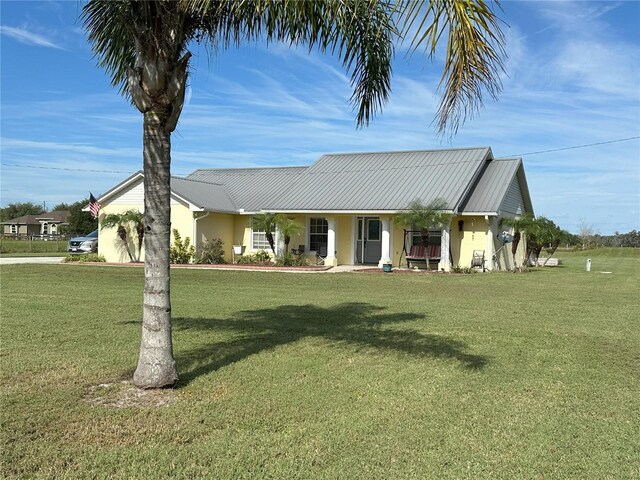 ranch-style house featuring a front yard and a porch