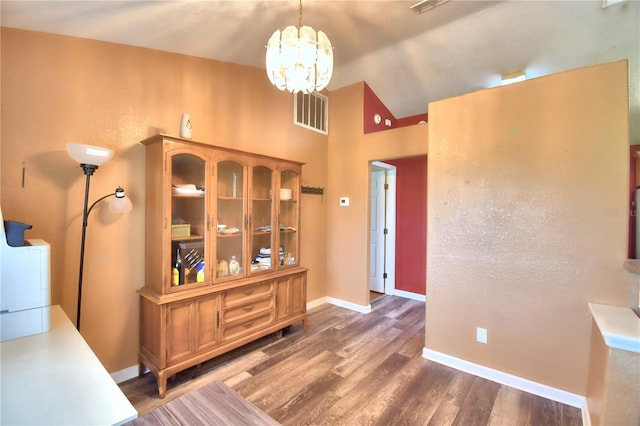 interior space featuring a notable chandelier and dark wood-type flooring