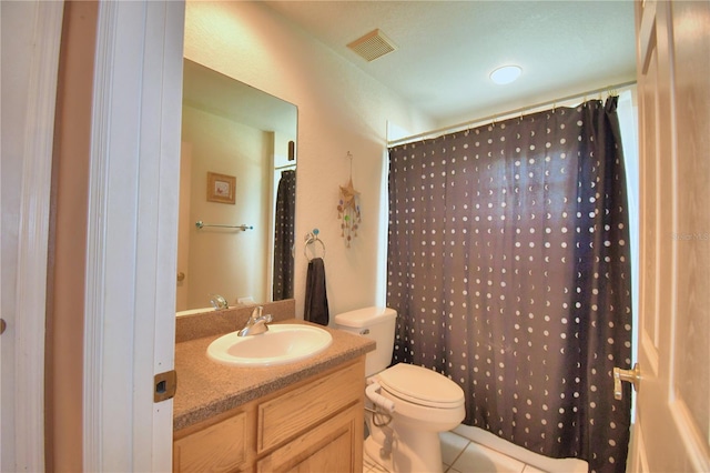 bathroom with tile patterned floors, curtained shower, vanity, and toilet