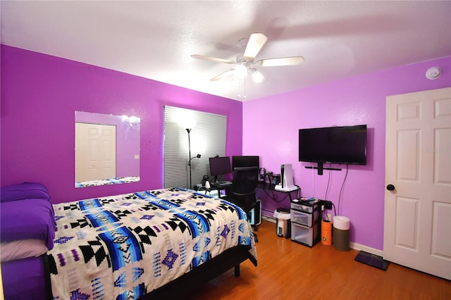 bedroom with ceiling fan and hardwood / wood-style floors