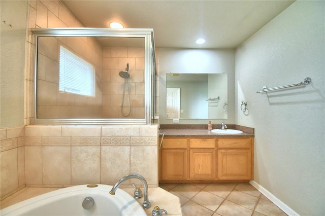 bathroom with plus walk in shower, vanity, and tile patterned floors