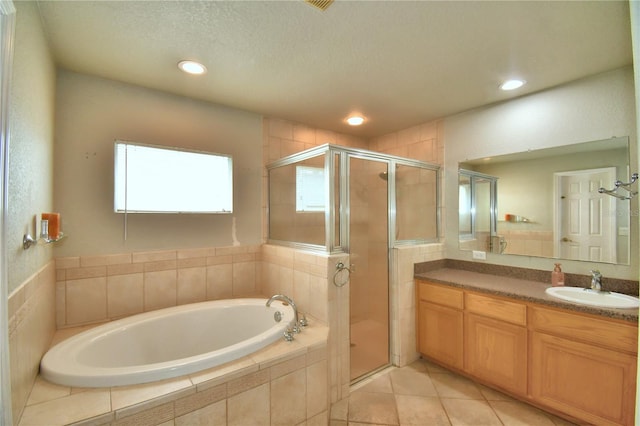 bathroom with vanity, separate shower and tub, tile patterned flooring, and a textured ceiling