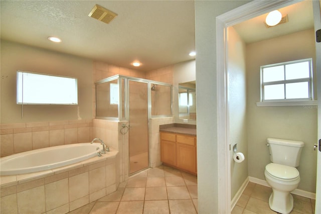 full bathroom with tile patterned flooring, a textured ceiling, separate shower and tub, vanity, and toilet