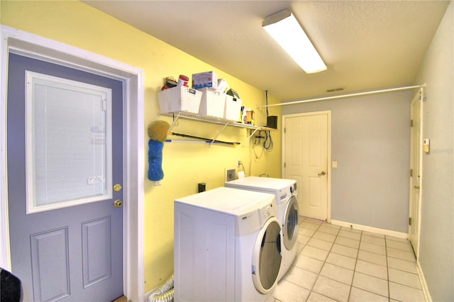 laundry room with light tile patterned flooring and washing machine and dryer