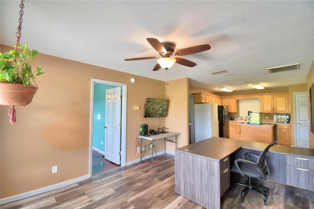 office area featuring a textured ceiling, dark hardwood / wood-style flooring, and ceiling fan