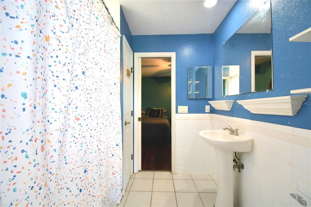 bathroom with tile walls and tile patterned flooring