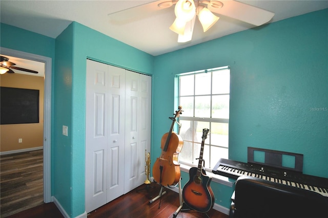 bedroom featuring ceiling fan, dark wood-type flooring, and a closet