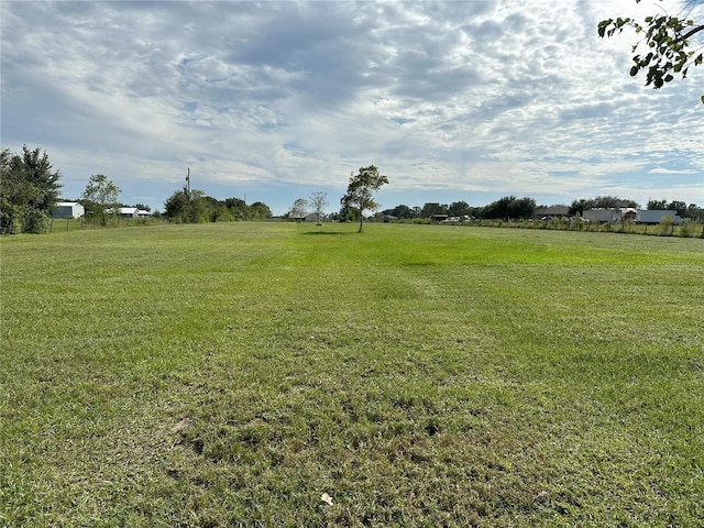 view of yard with a rural view