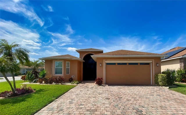 view of front of home with a front lawn and a garage