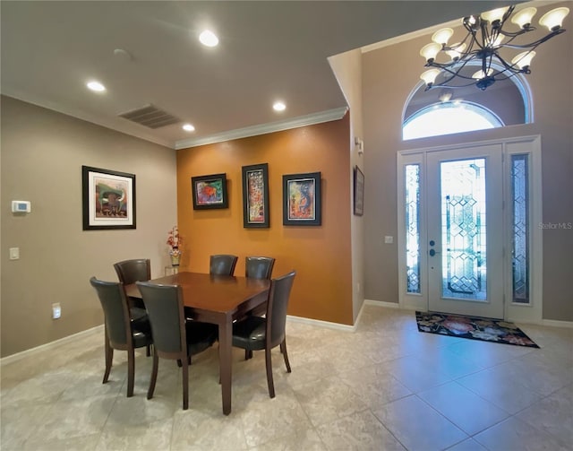 tiled dining area featuring an inviting chandelier and crown molding