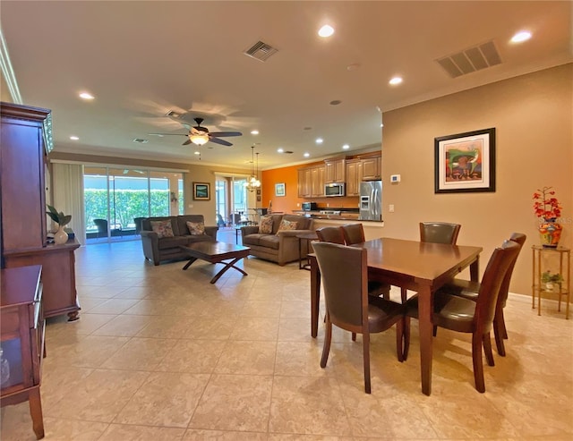 dining area featuring ornamental molding, ceiling fan, and light tile patterned floors