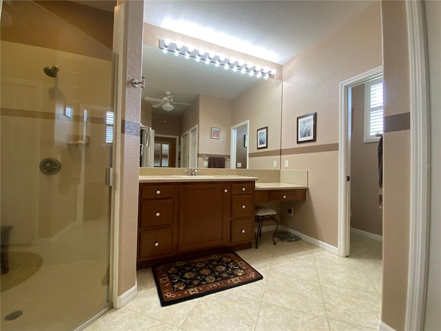 bathroom featuring tile patterned floors, ceiling fan, an enclosed shower, and vanity