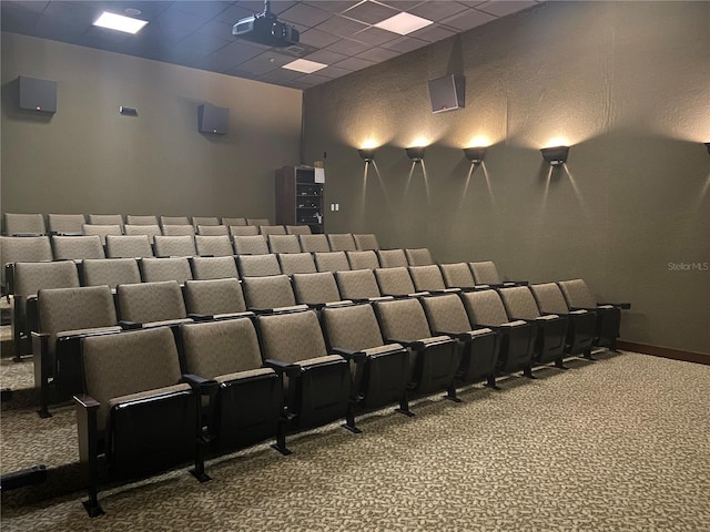 home theater room with carpet floors and a drop ceiling