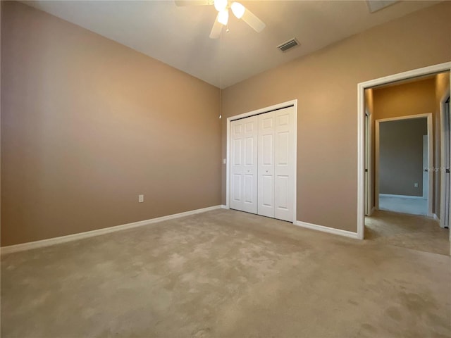 unfurnished bedroom featuring a closet, ceiling fan, and light colored carpet