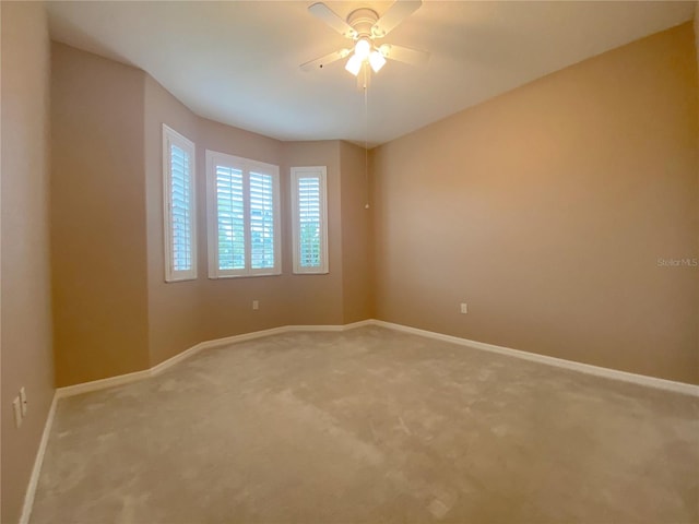 empty room with ceiling fan and carpet flooring